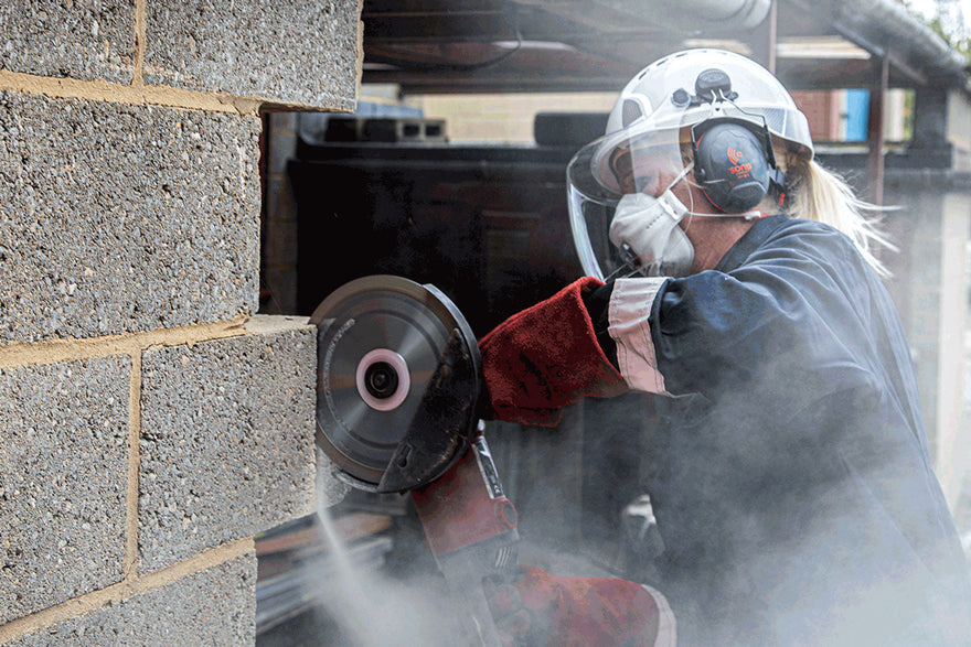 Worker Cutting While Wearing A Disposable FFP3 Dust Mask